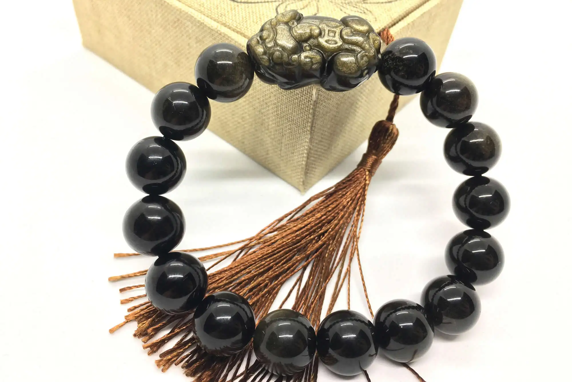 Crafting feng shui Pixiu bracelets, designed to attract wealth and protection.